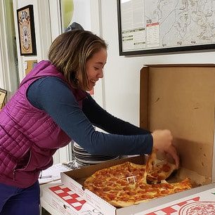 Anna Tang getting a slice of pizza at volunteer night