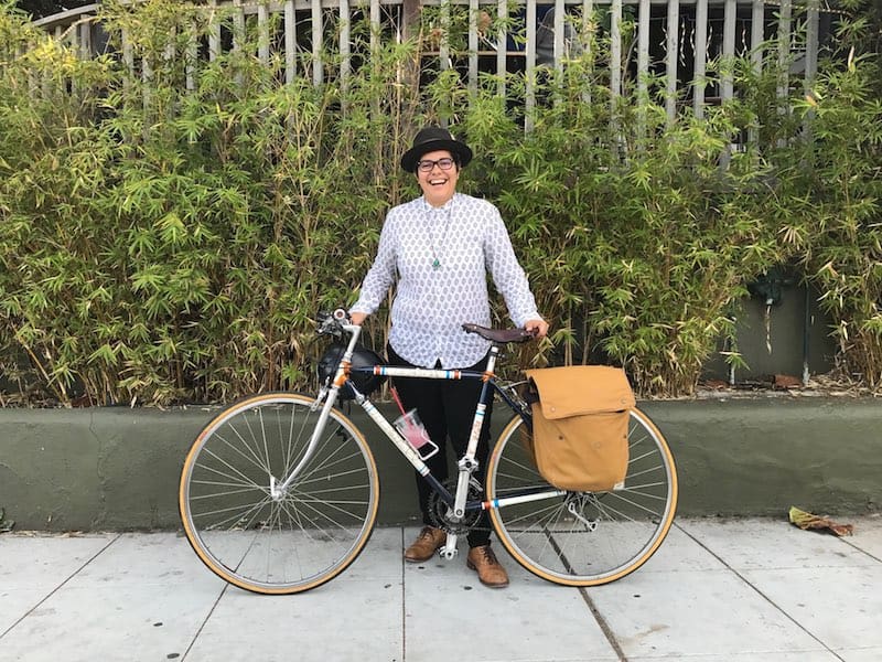 1970s Nishiki Racing Frame (Custom paint job by bike artist and mechanic Kate Cowper) with Monique G. López standing behind it!
