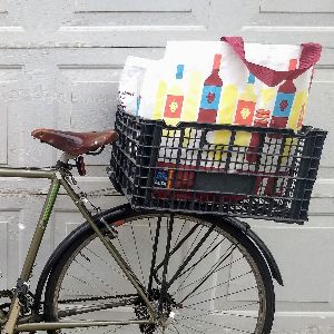 The back end of a bike with a crate filled with Aldi shopping bags